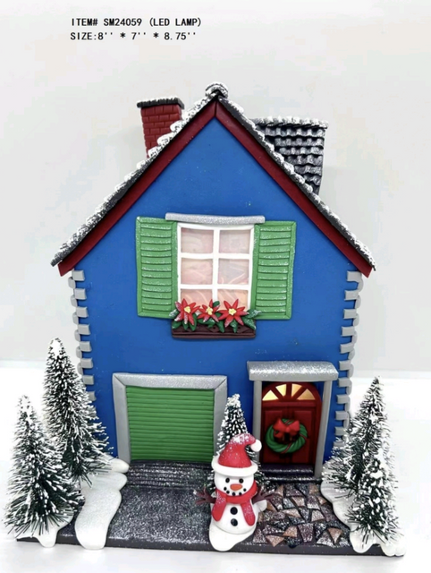 clay dough snowman is standing in front of the blue house light - 26