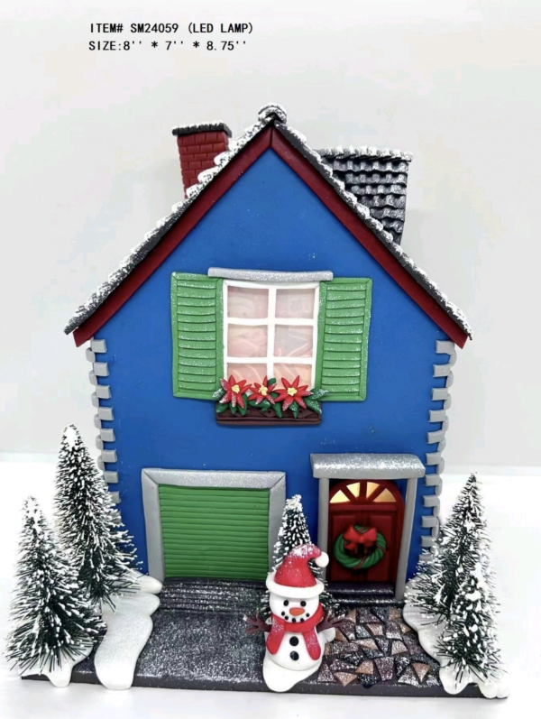 clay dough snowman is standing in front of the blue house light - 26