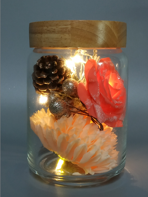Glass pot with Xmas ornaments lights