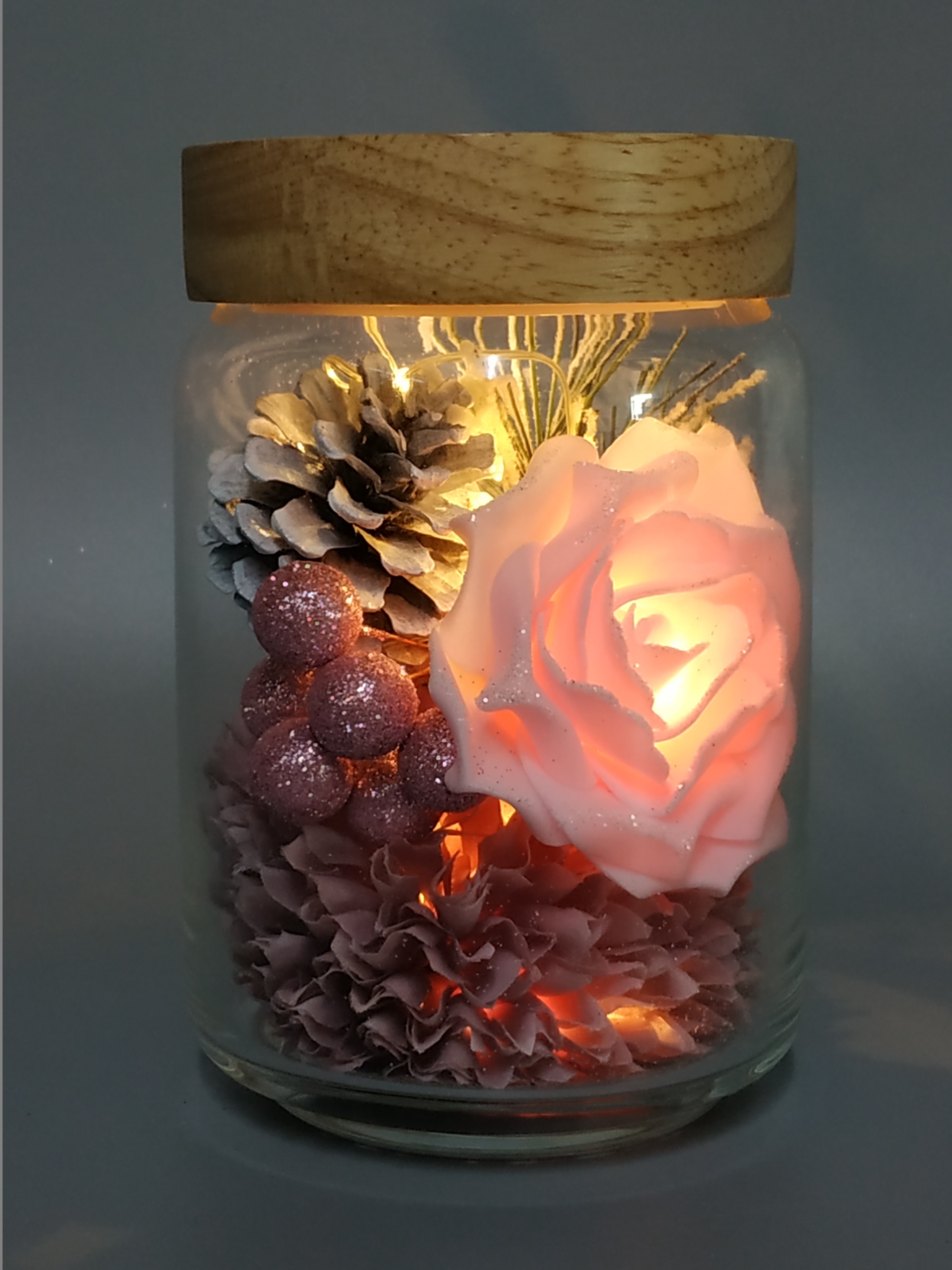 Glass pot with Xmas ornaments lights