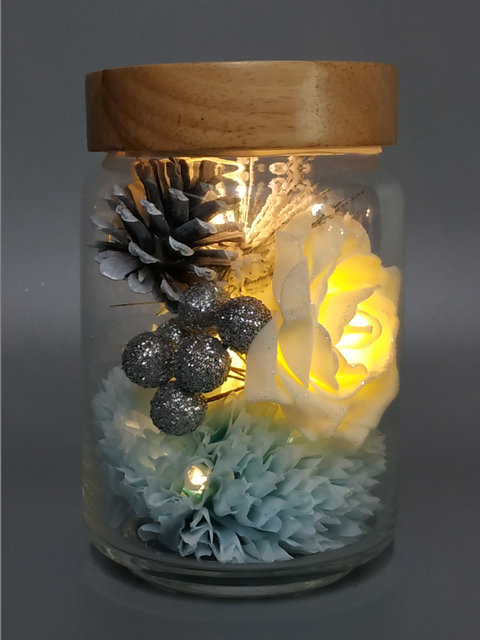 Glass pot with Xmas ornaments lights